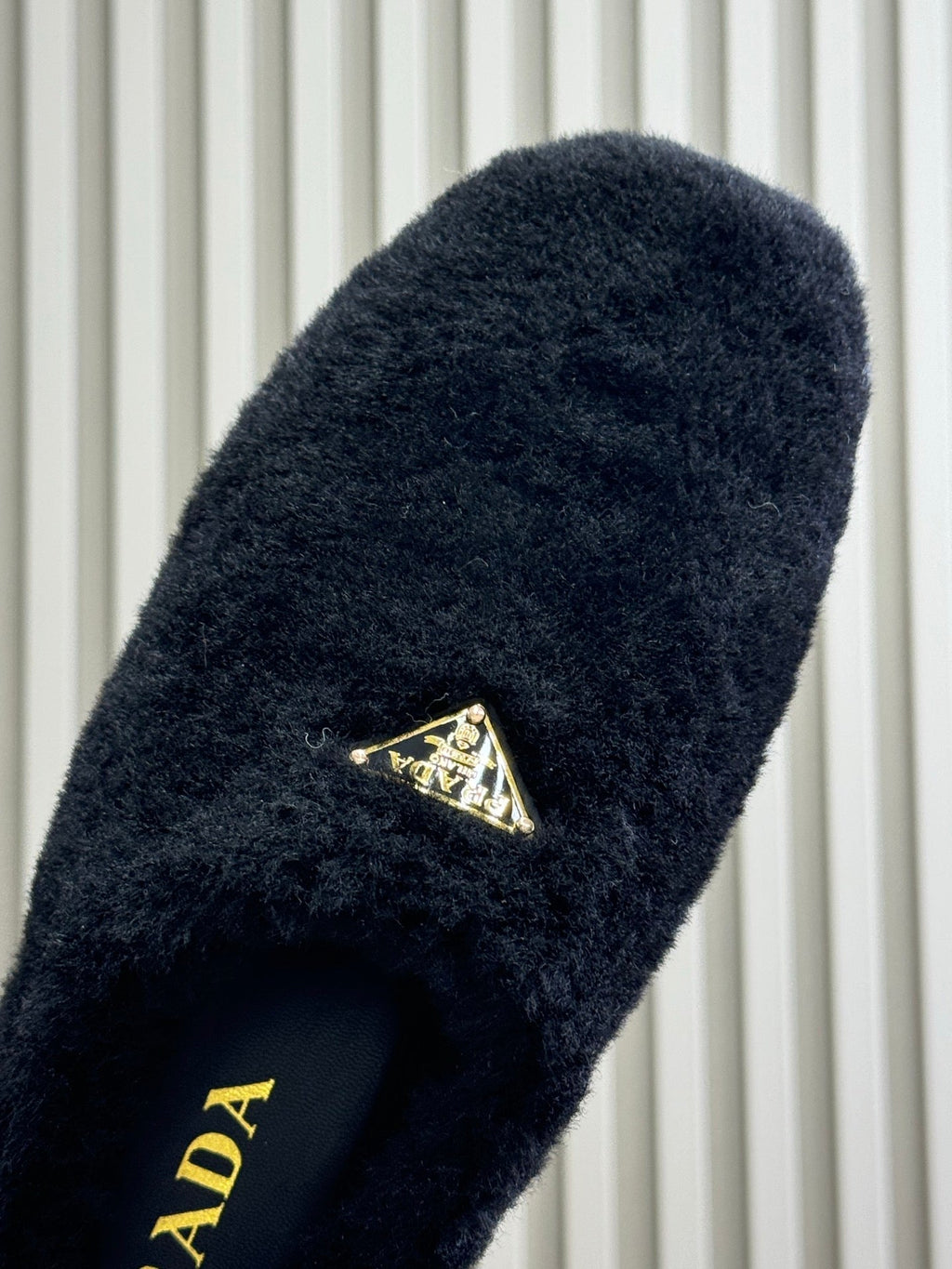 PRADA 25S CLOGS IN BLACK SHEARLING